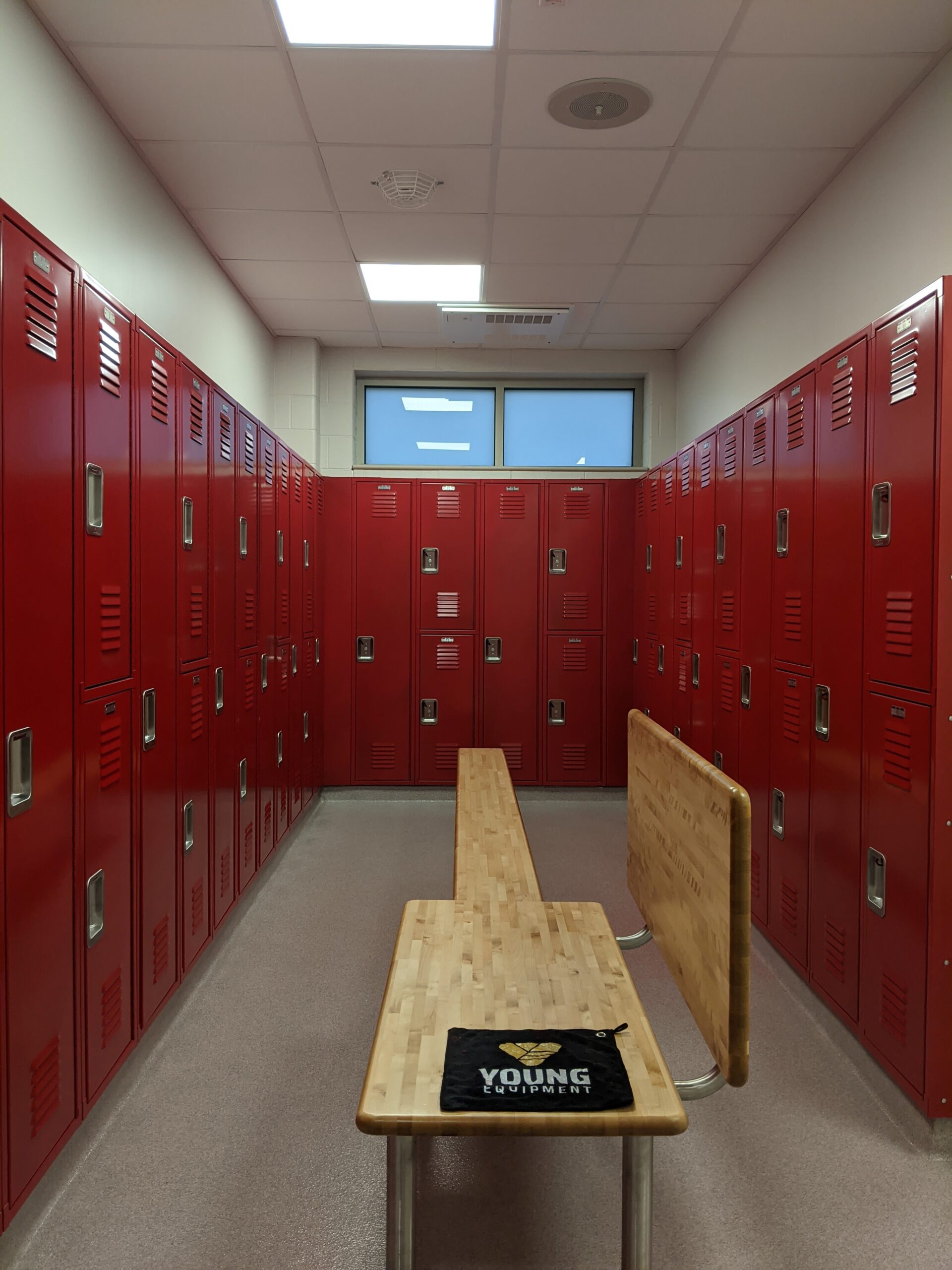 Red two tier and single tier lockers with bench